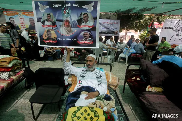 Palestinian men attend a rally in Gaza City, to show solidarity with Palestinian prisoners held in Israeli jails on May 7, 2012. At least 1,550 Palestinian prisoners are refusing food in Israeli jails in a protest agains...