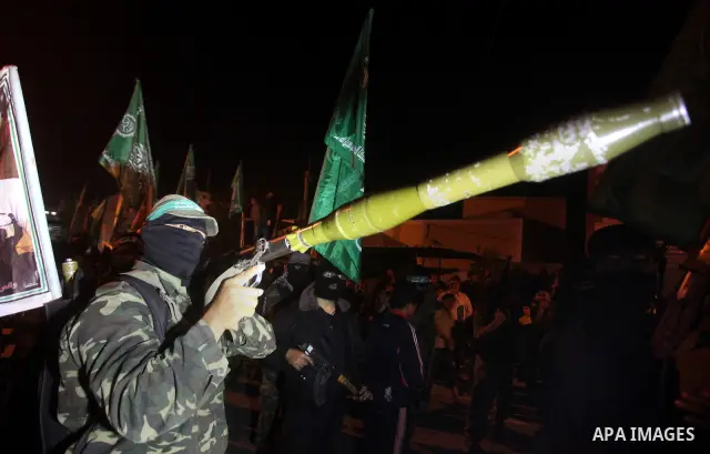 Masked Hamas militants march with their guns during a parade to show solidarity with Palestinian prisoners held in Israeli jails on May 7, 2012. At least 1,550 Palestinian prisoners are refusing food in Israeli jails in...