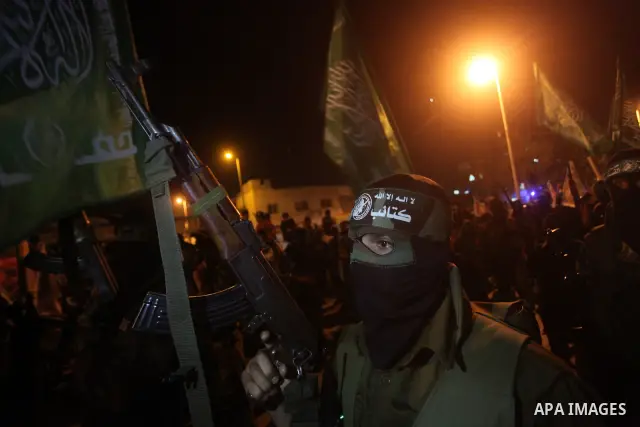 Masked Hamas militants march with their guns during a parade to show solidarity with Palestinian prisoners held in Israeli jails on May 7, 2012. At least 1,550 Palestinian prisoners are refusing food in Israeli jails in...