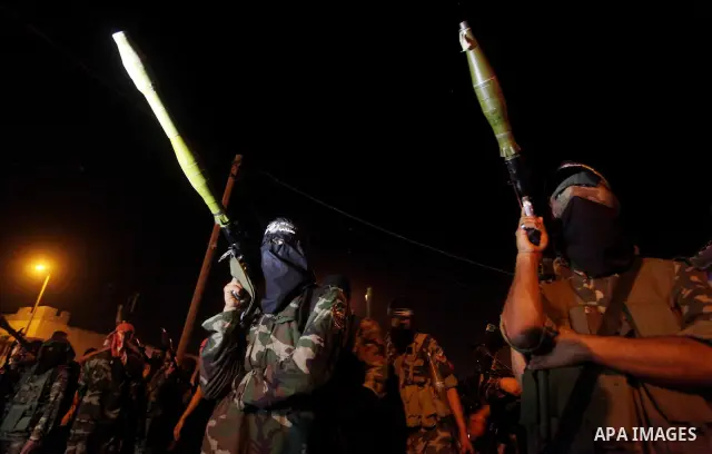Masked Hamas militants march with their guns during a parade to show solidarity with Palestinian prisoners held in Israeli jails on May 7, 2012. At least 1,550 Palestinian prisoners are refusing food in Israeli jails in...