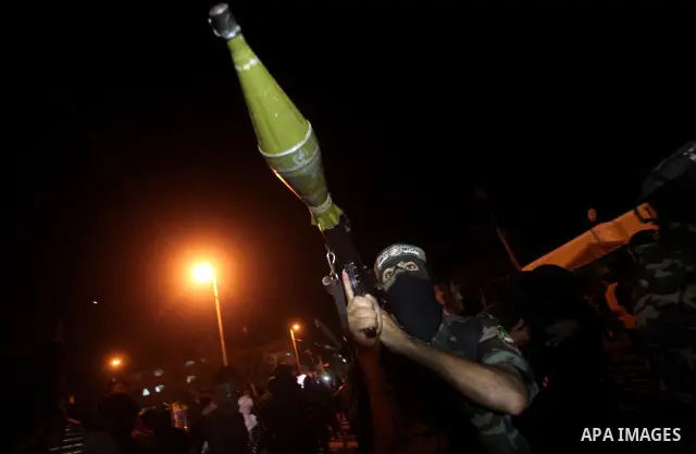Masked Hamas militants march with their guns during a parade to show solidarity with Palestinian prisoners held in Israeli jails on May 7, 2012. At least 1,550 Palestinian prisoners are refusing food in Israeli jails in...