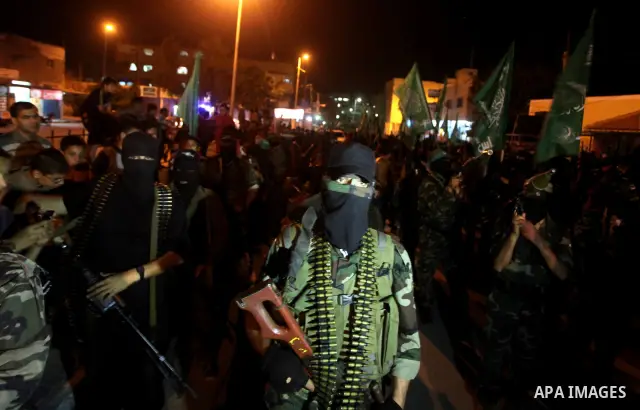 Masked Hamas militants march with their guns during a parade to show solidarity with Palestinian prisoners held in Israeli jails on May 7, 2012. At least 1,550 Palestinian prisoners are refusing food in Israeli jails in...