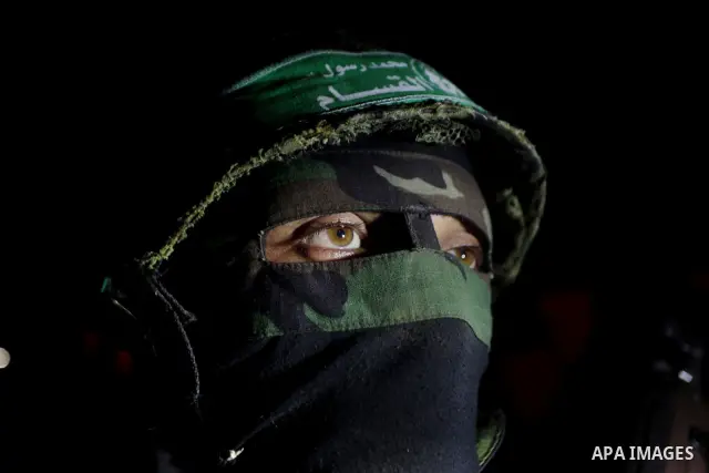 Masked Hamas militants march with their guns during a parade to show solidarity with Palestinian prisoners held in Israeli jails on May 7, 2012. At least 1,550 Palestinian prisoners are refusing food in Israeli jails in...