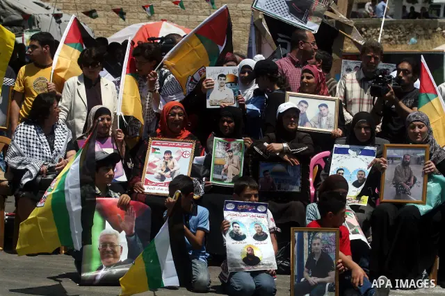 Palestinians participate in a rally supporting Palestinian inmates on hunger strike since mid-April 2012, in the West Bank City of Ramallah, May 8, 2012. A Palestinian rights group said recently that half of about 5,000...