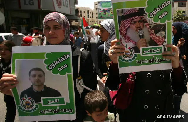 Palestinians hold a sit-in in front of the house of prisoner Thaer Halahle in the West Bank village of Kharas near Hebron, on May 8, 2012. Two Palestinian prisoners Thaer Halahleh, 33, and Bilal Diab, 27, who are on thei...