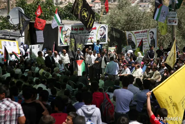Palestinians hold a sit-in in front of the house of prisoner Thaer Halahle in the West Bank village of Kharas near Hebron, on May 8, 2012. Two Palestinian prisoners Thaer Halahleh, 33, and Bilal Diab, 27, who are on thei...
