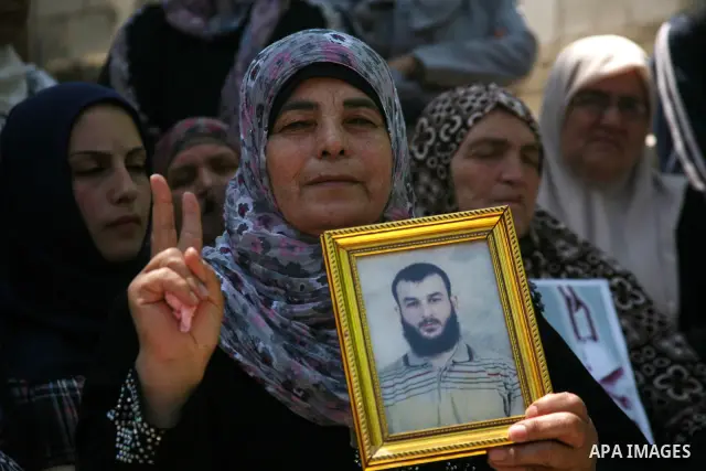 Palestinians hold a sit-in in front of the house of prisoner Thaer Halahle in the West Bank village of Kharas near Hebron, on May 8, 2012. Two Palestinian prisoners Thaer Halahleh, 33, and Bilal Diab, 27, who are on thei...