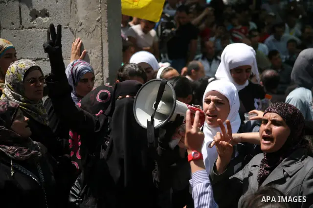 Palestinians hold a sit-in in front of the house of prisoner Thaer Halahle in the West Bank village of Kharas near Hebron, on May 8, 2012. Two Palestinian prisoners Thaer Halahleh, 33, and Bilal Diab, 27, who are on thei...