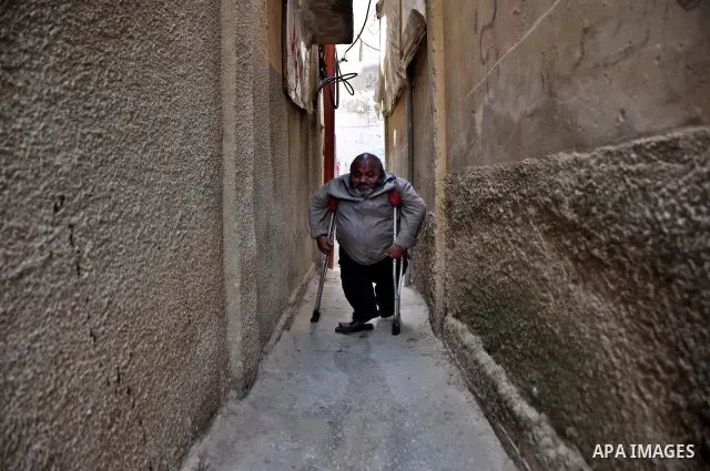 Marwan Abedah, a 58-year-old Palestinian refugee, leave their home in the alleys of the Askar refugee camp in the West Bank City of Nablus, 06 May 2012. The Abedah family, which has three handicapped relatives including...