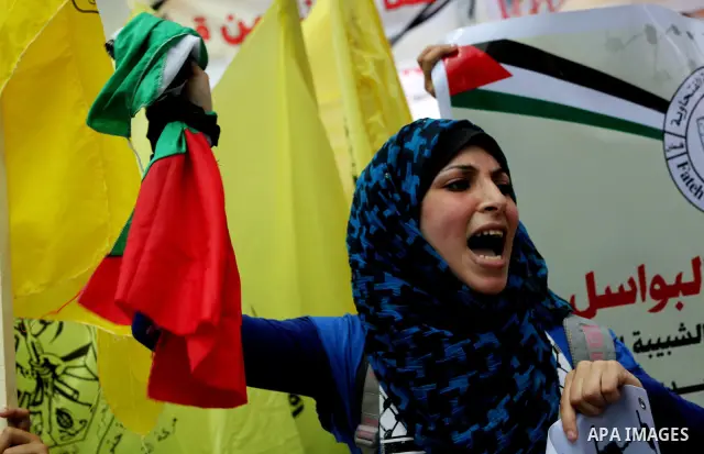 Palestinian woman shouts slogans aduring a demonstration in Gaza City on May 8, 2012 in solidarity with the prisoners. At least 1,550 imprisoned Palestinians are now taking part in a mass hunger strike. Photo by Ashraf A...