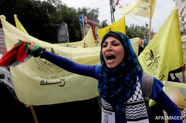 Palestinian woman shouts slogans aduring a demonstration in Gaza City on May 8, 2012 in solidarity with the prisoners. At least 1,550 imprisoned Palestinians are now taking part in a mass hunger strike. Photo by Ashraf A...