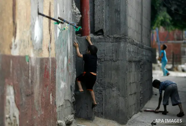 A Palestinian children play in front of their house in the Rafah refugee camp in the southern area of the Gaza Strip on May 09 2012. On May 15 Palestinians will mark "Nakba," or catastrophe, of Israel's founding in a 194...