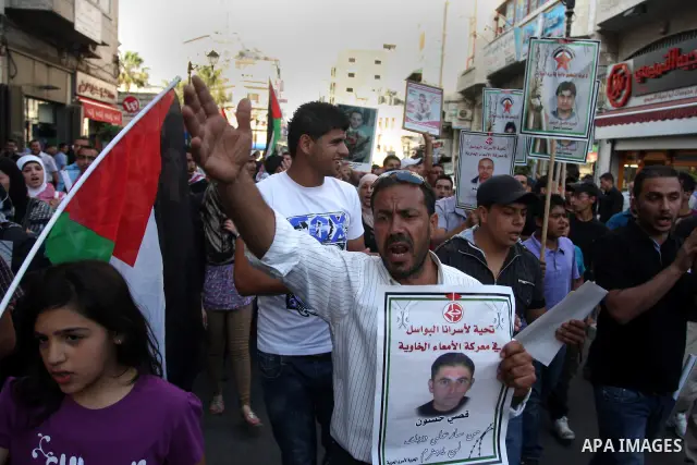 Palestinians participate in a rally supporting Palestinian inmates on hunger strike since mid-April 2012, in the West Bank City of Ramallah, May 9, 2012. A Palestinian rights group said recently that half of about 5,000...