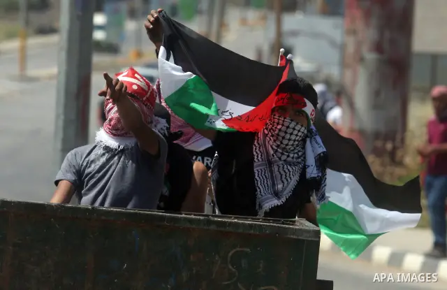 Palestinian protesters take part during a demonstration outside the Ofer Prison close to the West Bank city of Ramallah, in support of Palestinian prisoners on hunger strike in Israeli jails, on May 10, 2012. Israel's pr...