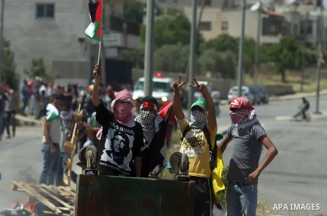 Palestinian protesters take part during a demonstration outside the Ofer Prison close to the West Bank city of Ramallah, in support of Palestinian prisoners on hunger strike in Israeli jails, on May 10, 2012. Israel's pr...