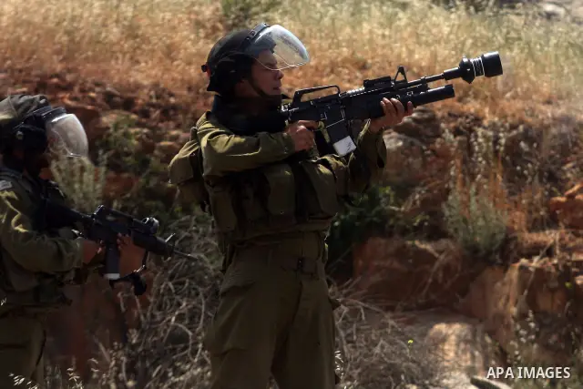Israeli soldiers fire rubber bullets and teargas towards Palestinian protesters during clashes outside the Ofer Prison close to the West Bank city of Ramallah, following a demonstration in support of Palestinian prisoner...