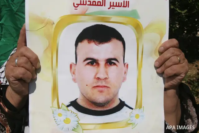 Palestinians hold portraits of their relatives held in Israeli jails during a protest in solidarity with prisoners on hunger strike, outside the European Union Representative Office in East Jerusalem May 10, 2012. Palest...