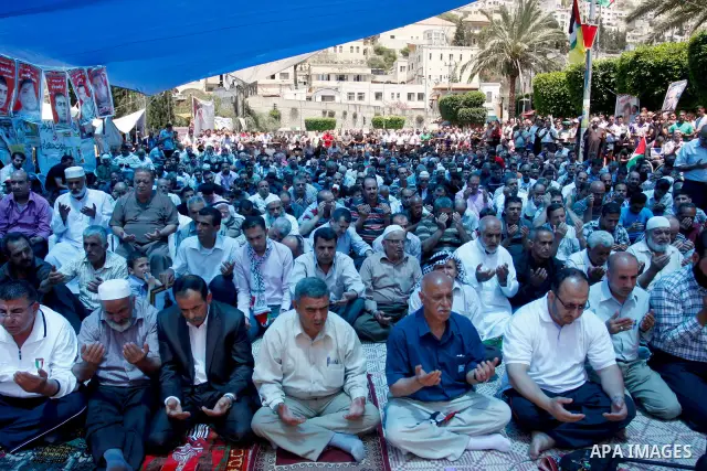 Palestinians perform Friday prayers during a sit-in, in the West Bank city of Nablus, May 11, 2012. Palestinians held in prayer outside a tent, in solidarity with prisoners who have been waging a hunger strike in Israeli...