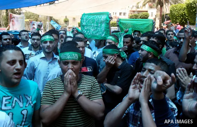 Palestinians participate a demonstration, and hold portraits of prisoners held in Israeli jails, following perform Friday prayers during a sit-in, in the West Bank city of Nablus, May 11, 2012. Palestinians held in praye...