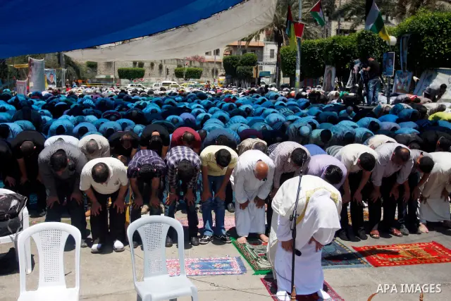 Palestinians perform Friday prayers during a sit-in, in the West Bank city of Nablus, May 11, 2012. Palestinians held in prayer outside a tent, in solidarity with prisoners who have been waging a hunger strike in Israeli...