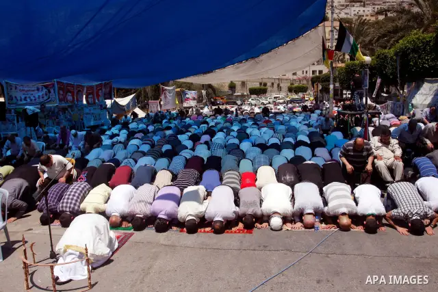 Palestinians perform Friday prayers during a sit-in, in the West Bank city of Nablus, May 11, 2012. Palestinians held in prayer outside a tent, in solidarity with prisoners who have been waging a hunger strike in Israeli...