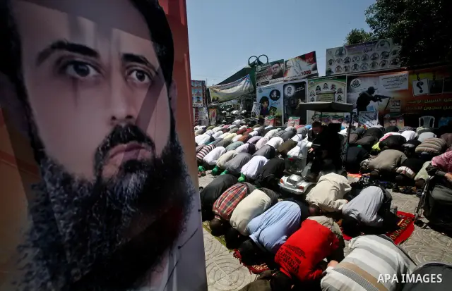 Palestinians attend Friday prayers in Gaza City in support of more than a thousand prisoners who are on an open-ended hunger strike in Israeli jails on May 11, 2012. At least 1,550 Palestinian prisoners are now on hunger...