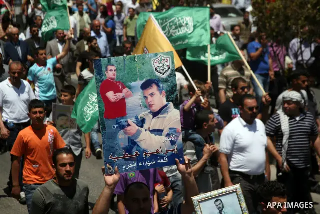 Palestinians participate a demonstration, and hold portraits of prisoners held in Israeli jails, solidarity with prisoners who have been waging a hunger strike in Israeli jails, on May 11, 2012, in the West Bank city of...