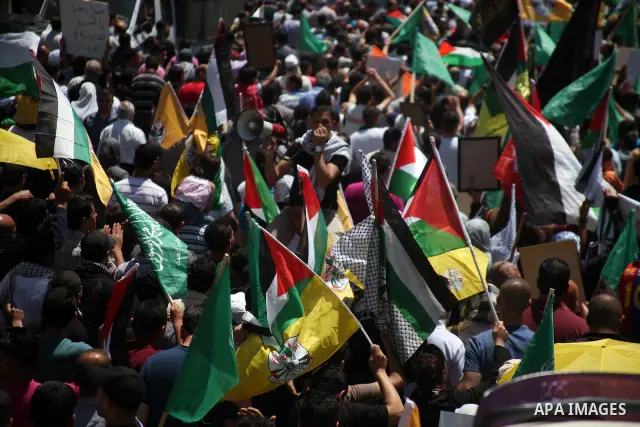 Palestinians participate a demonstration, and hold portraits of prisoners held in Israeli jails, solidarity with prisoners who have been waging a hunger strike in Israeli jails, on May 11, 2012, in the West Bank city of...