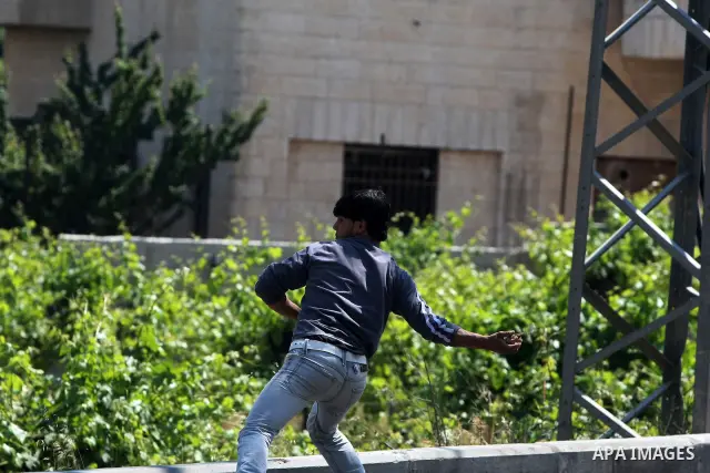 Palestinians throw stones at Israeli army during clashes broke out in the village of Beit Ommar, near the northern West Bank city of Hebron, following a demonstration solidarity with prisoners who have been waging a hung...