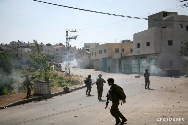 Israeli soldiers fire tear gas at stone throwing Palestinians after clashes broke out during a protest in solidarity with incarcerated Palestinians on hunger strike in Israeli jails on May 11, 2012, in the village of Bei...