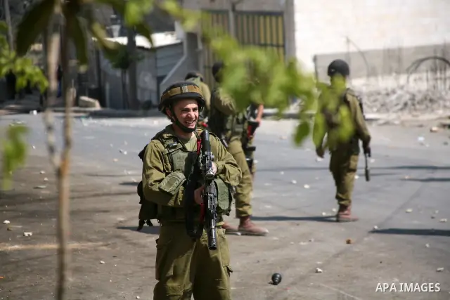 Israeli soldiers fire tear gas at stone throwing Palestinians after clashes broke out during a protest in solidarity with incarcerated Palestinians on hunger strike in Israeli jails on May 11, 2012, in the village of Bei...
