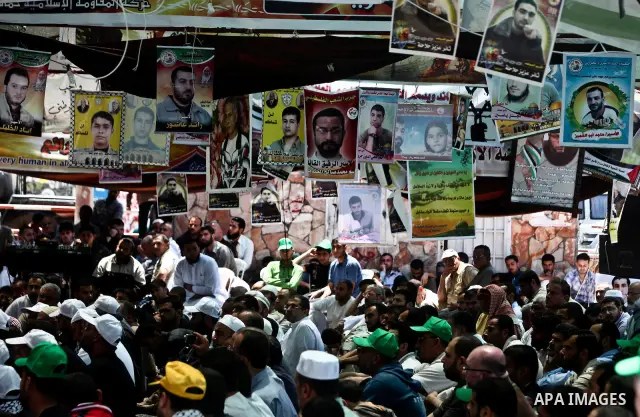 Palestinians attend Friday prayers in Gaza City in support of more than a thousand prisoners who are on an open-ended hunger strike in Israeli jails on May 11, 2012. At least 1,550 Palestinian prisoners are now on hunger...