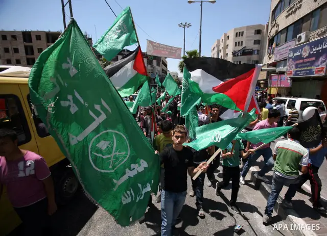 Palestinians participate a demonstration, and hold portraits of prisoners held in Israeli jails, solidarity with prisoners who have been waging a hunger strike in Israeli jails, on May 11, 2012, in the West Bank city of...
