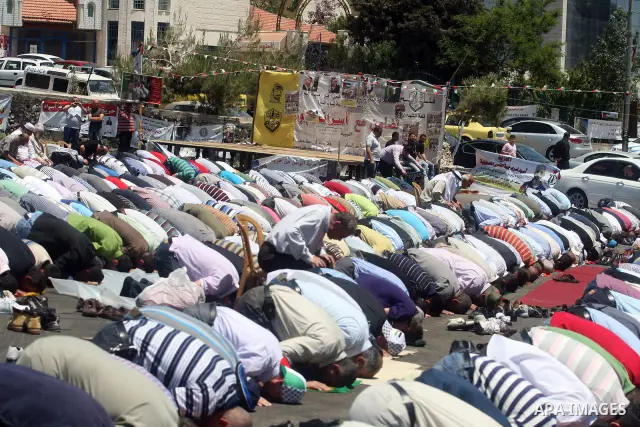 Palestinians perform Friday prayers during a sit-in, in the West Bank city of Ramallah, May 11, 2012. Palestinians held in prayer outside a tent, in solidarity with prisoners who have been waging a hunger strike in Israe...