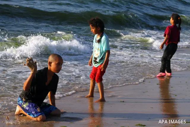 Palestinians enjoy a day on the beach of Khan Yunis, south of the Gaza Strip, on May 12, 2012. Photo by Ashraf Amra