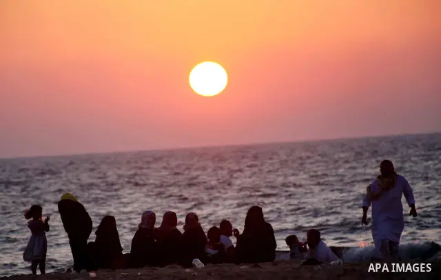 Palestinians enjoy a day on the beach of Khan Yunis, south of the Gaza Strip, on May 12, 2012. Photo by Ashraf Amra