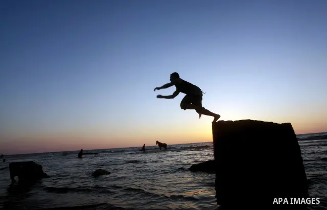 Palestinians enjoy a day on the beach of Khan Yunis, south of the Gaza Strip, on May 12, 2012. Photo by Ashraf Amra
