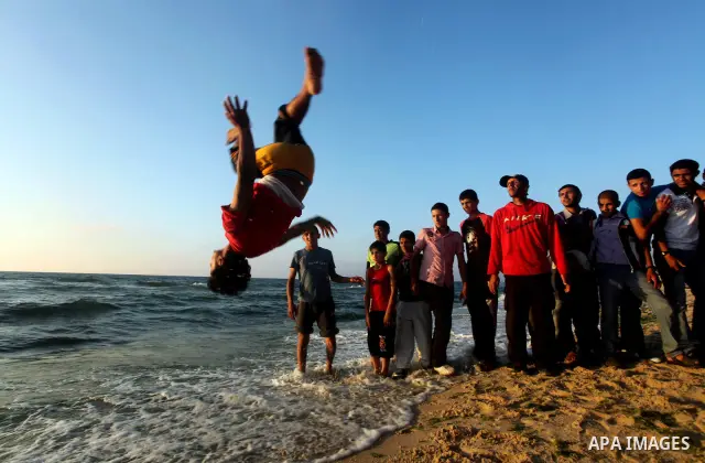 Palestinians enjoy a day on the beach of Khan Yunis, south of the Gaza Strip, on May 12, 2012. Photo by Ashraf Amra