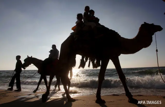 Palestinians enjoy a day on the beach of Khan Yunis, south of the Gaza Strip, on May 12, 2012. Photo by Ashraf Amra