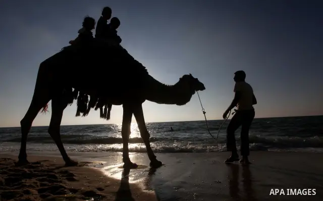 Palestinians enjoy a day on the beach of Khan Yunis, south of the Gaza Strip, on May 12, 2012. Photo by Ashraf Amra