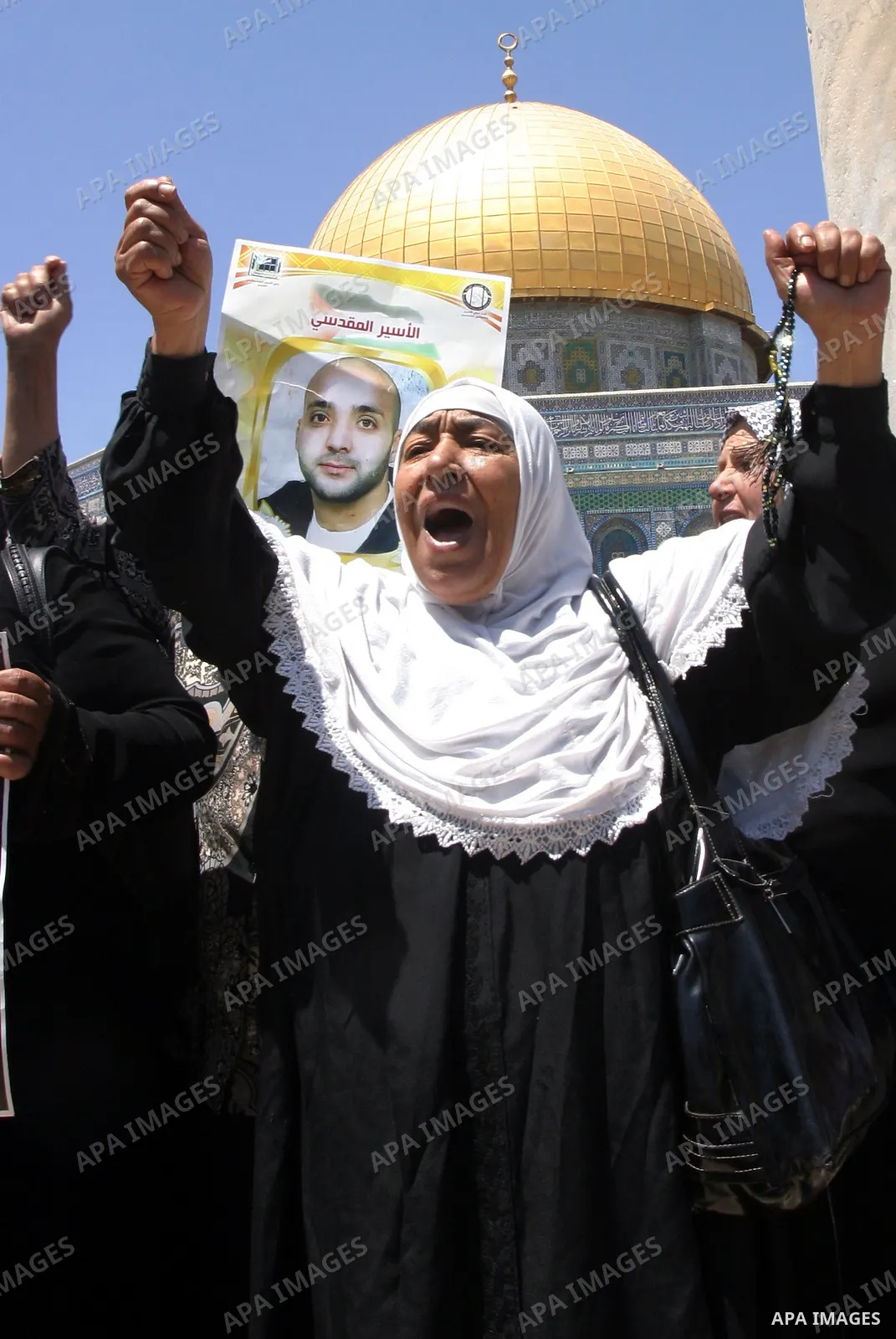 Palestinians hold portraits of relatives held in Israeli jails during a protest on the compound known to Muslims as Noble Sanctuary and to Jews as Temple Mount in Jerusalem's Old City, to show solidarity with prisoners o...
