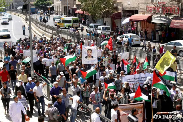 Palestinians hold portraits of relatives held in Israeli jails during a protest on the compound known to Muslims as Noble Sanctuary and to Jews as Temple Mount in Jerusalem's Old City, to show solidarity with prisoners o...