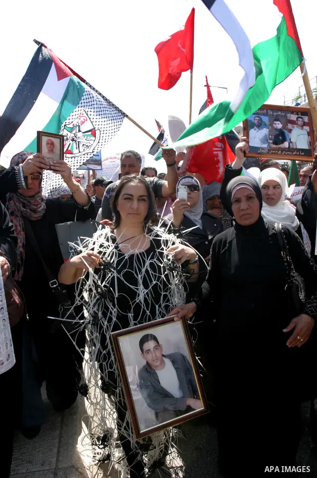 Palestinians hold portraits of relatives held in Israeli jails during a protest on the compound known to Muslims as Noble Sanctuary and to Jews as Temple Mount in Jerusalem's Old City, to show solidarity with prisoners o...