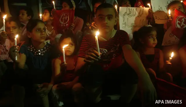 Palestinian children light candles, during a rally outside a tent solidarity with prisoners who have been waging a hunger strike in Israeli jails, in Gaza City May 11, 2012. A hunger strike by Palestinian prisoners again...