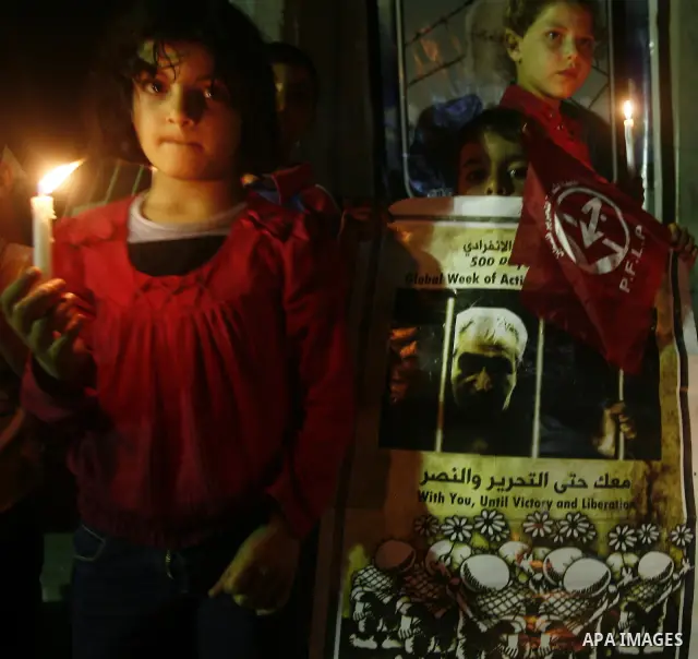Palestinian children light candles, during a rally outside a tent solidarity with prisoners who have been waging a hunger strike in Israeli jails, in Gaza City May 11, 2012. A hunger strike by Palestinian prisoners again...