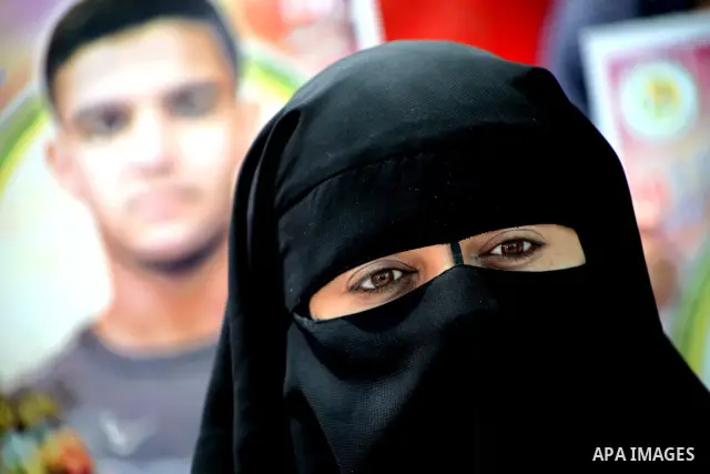 Palestinian women hold pictures of their jailed relatives during a sit-in in Gaza city in support of over 1,550 prisoners observing a hunger strike to demand better conditions in Israeli jails on May 12, 2012. The World...