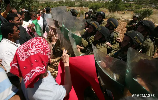Palestinian protesters and foreign activists scuffle with Israeli soldiers during a demonstration ahead of "Nakba Day" in Beit Omar village, north of the West Bank town of Hebron, on May 12, 2012 where Israeli soldiers t...