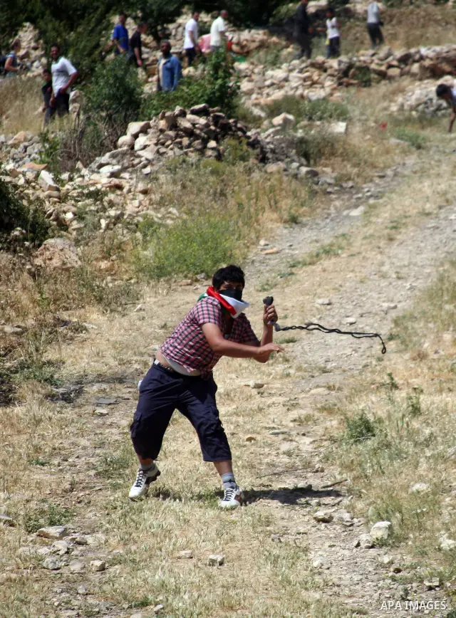 Palestinian stone throwers clash with Israeli soldiers during a demonstration ahead of "Nakba Day" in Beit Omar village, north of the West Bank town of Hebron, on May 12, 2012 where Israeli soldiers tried to evacuate dem...
