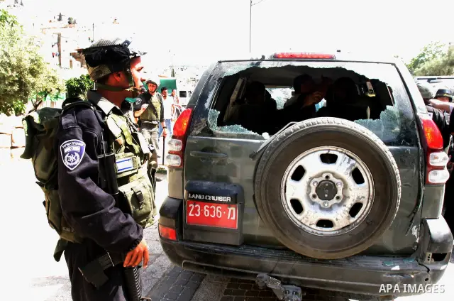 Israeli riot police detain a Palestinian man in a car, whose rear window was smashed during clashes between Palestinian youth and the Israeli police in the east Jerusalem neighbourhood of Silwan on May 12, 2012. Israel i...