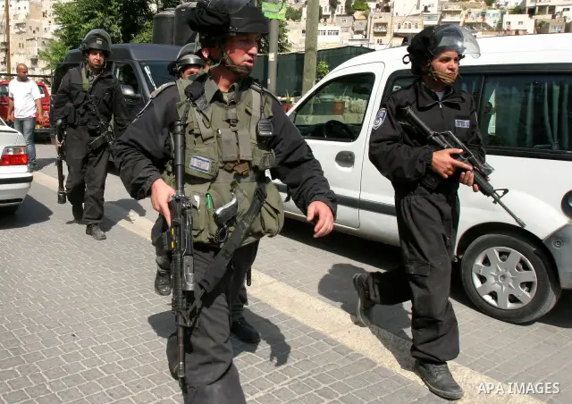 Israeli riot police fire teargas, before arresting a Palestinian during clashes between Palestinian youth and the Israeli police in the east Jerusalem neighbourhood of Silwan on May 12, 2012. Israel is to reply on May 12...